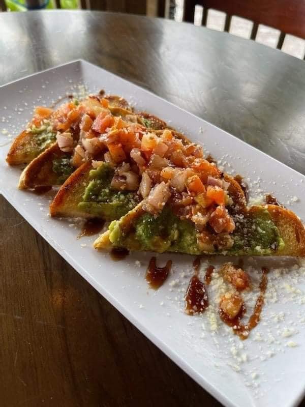 Avocado toast topped with fresh tomato