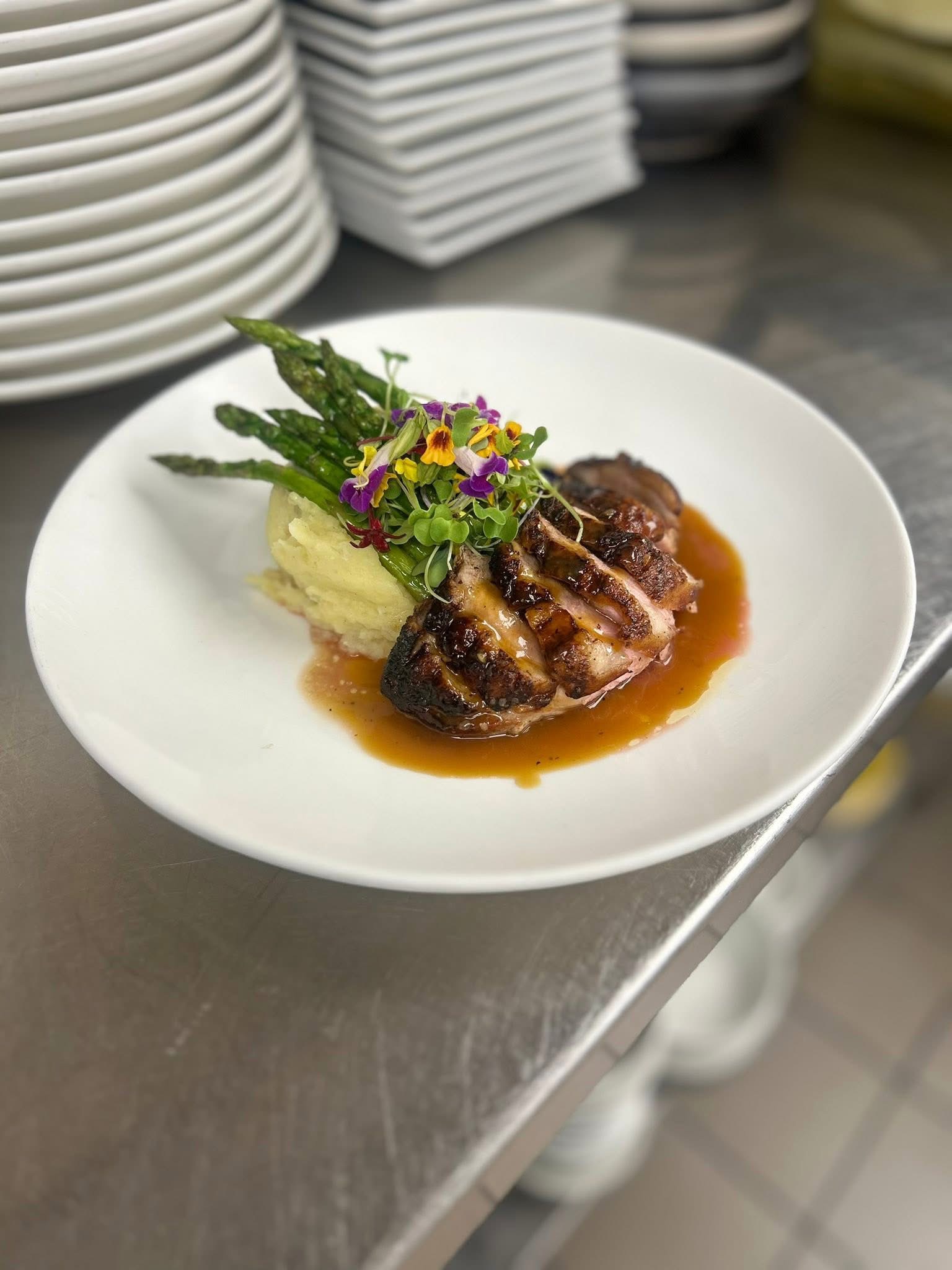 Chef-plated entrée with mashed potatoes and asparagus